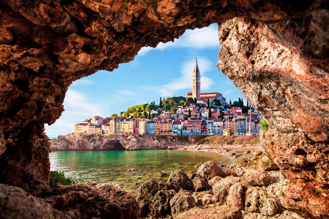 The colorfully painted beach houses of Slovenia as seen from a cave